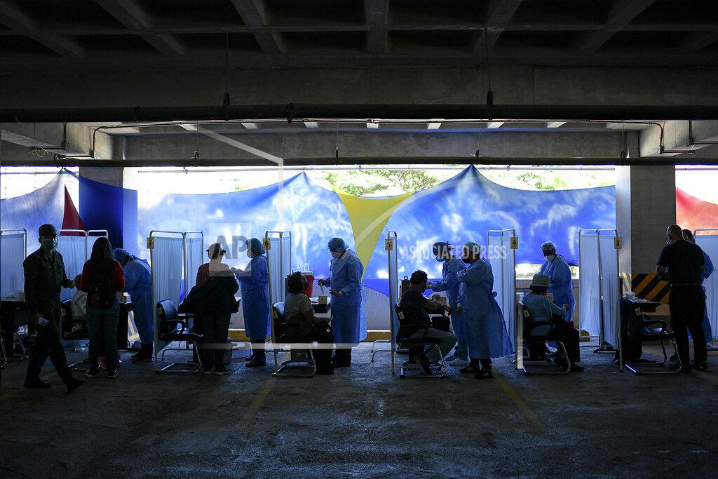 Matias Delacroix Healthcare workers prepare doses of the Sputnik V vaccine for COVID-19 as seniors and those considered high risk for contagion are eligible at a vaccination center set up in the parking lot of the Armed Forces Social Prevision Institute (IPSFA) in Caracas, Venezuela, Monday, June 7, 2021. (AP Photo/Matias Delacroix)