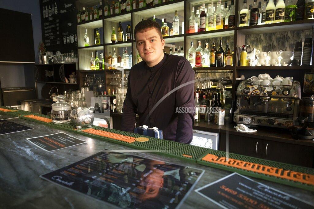 Dmitri Lovetsky Mikhail Kavin, manager of the Commode bar in St. Petersburg, Russia, speaks during his interview with The Associated Press on Wednesday, March 24, 2021. Police raided Commode in December for serving customers behind closed doors past 11 p.m. in violation of coronavirus restrictions. Even with flouting the rules, the bar hasn't bounced back to its pre-pandemic level of sales, Kavin said. (AP Photo/Dmitri Lovetsky)