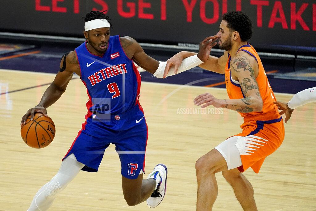 Matt York Detroit Pistons forward Jerami Grant (9) drives against Phoenix Suns forward Abdel Nader during the first half of an NBA basketball game, Friday, Feb. 5, 2021, in Phoenix. (AP Photo/Matt York)