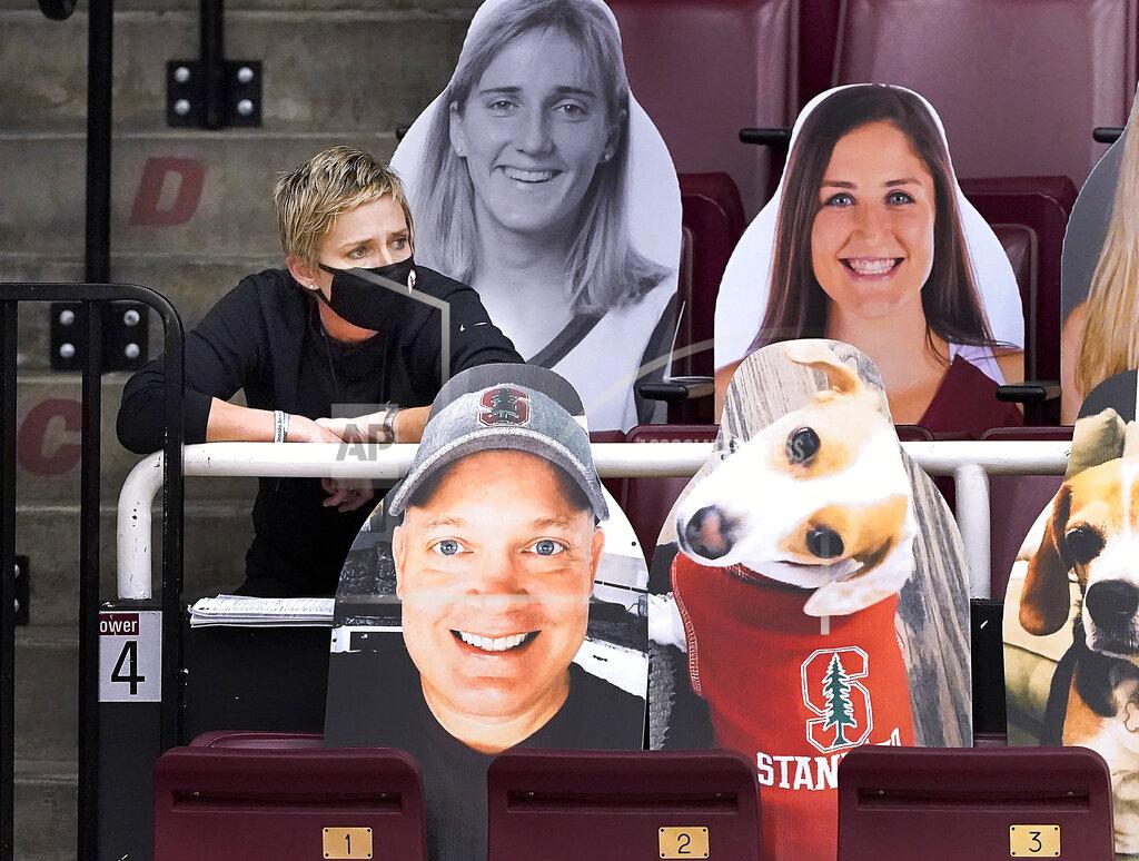 Tony Avelar Stanford Cardinal assistant coach Kate Paye, left, looks on from the bleachers during an NCAA college basketball game against Cal Poly, Wednesday, Nov. 25, 2020, Stanford, Calif. Paye was not allow to join the team on the bench due to her not receiving her COVID-19 test results. (AP Photo/Tony Avelar)