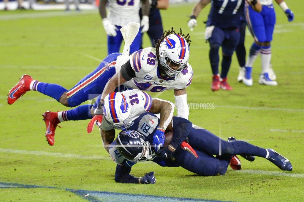 Mark Zaleski Tennessee Titans tight end Jonnu Smith (81) scores a touchdown on a 7-yard pass reception as he is hit by Buffalo Bills strong safety Dean Marlowe (31) and middle linebacker Tremaine Edmunds (49) in the second half of an NFL football game Tuesday, Oct. 13, 2020, in Nashville, Tenn. (AP Photo/Mark Zaleski)