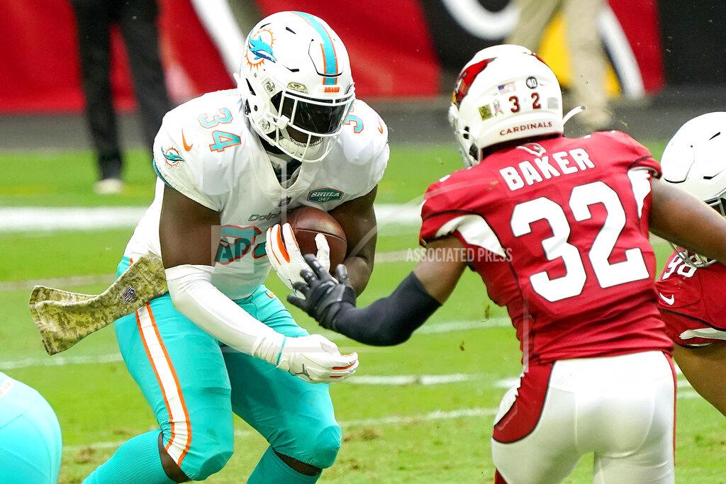 Rick Scuteri Miami Dolphins running back Jordan Howard (34) runs the ball as Arizona Cardinals strong safety Budda Baker (32) defends during the first half of an NFL football game, Sunday, Nov. 8, 2020, in Glendale, Ariz. (AP Photo/Rick Scuteri)