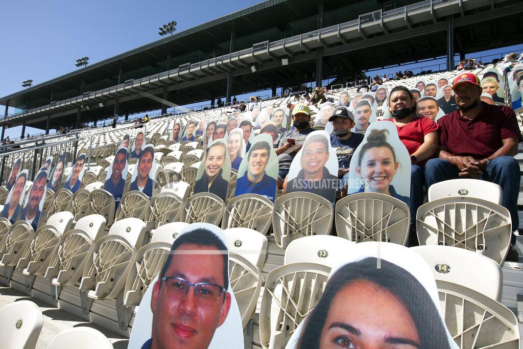D. Ross Cameron Cardboard placards outnumber live fans before a NASCAR Cup Series race, Sunday, June 6, 2021, at Sonoma Raceway in Sonoma, Calif. California health officials are still enforcing COVID-19 protocols that include mask-wearing and social distancing. (AP Photo/D. Ross Cameron)