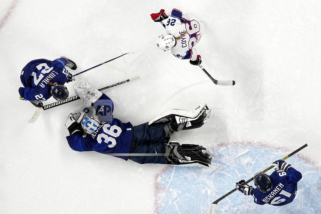 Petr David Josek Finland goalkeeper Anni Keisala (36) covers up puck as Julia Liikala (27) and United States' Kendall Coyne Schofield (26) watch for the rebound during a preliminary round women's hockey game at the 2022 Winter Olympics, Thursday, Feb. 3, 2022, in Beijing. (AP Photo/Petr David Josek)