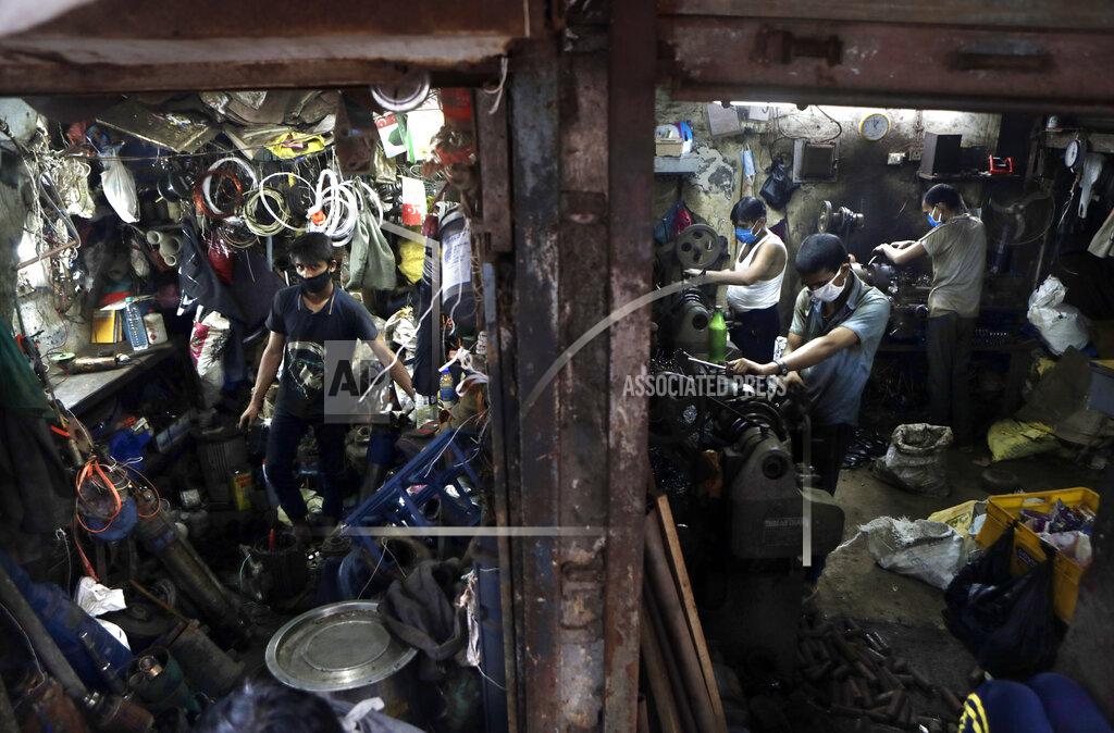 Rajanish Kakade People work in a workshop at Dharavi, one of Asia's largest slums, in Mumbai, India, Friday, Sept. 25, 2020. Millions of distressed Indian manufacturers and traders are counting on the eagerly-awaited October-December festive season to rescue them from their coronavirus catastrophe. But spending may be the last thing on the minds of many Indians who have lost their jobs or businesses in the pandemic downturn. The government began easing a stringent two-month-long lockdown in June, but business is only a quarter to a fifth of usual and customers are scarce, said Praveen Khandelwal, general secretary of the Confederation of All India Traders. (AP Photo/Rajanish Kakade)