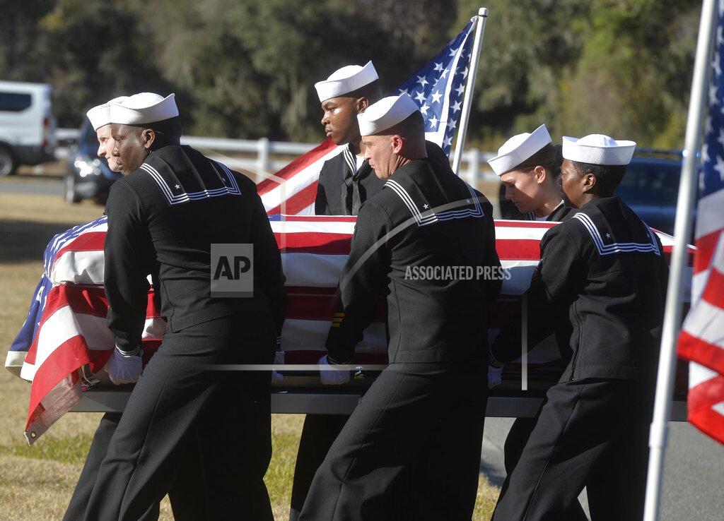 Steve Bisson FILE - In this Dec. 16, 2019 file photo, sailors carry the casket of Cameron Walters at Oak Hill Cemetery in Richmond Hill, Ga. Walters was one of the three Navy sailors killed in a Saudi gunman's attack at Pensacola Naval Air Station in Florida on Dec. 6. The FBI has found a link between the gunman in a deadly attack at a military base last December and an al-Qaida operative. That's according to a U.S. official who spoke to The Associated Press on Monday. (Steve Bisson/Savannah Morning News via AP)