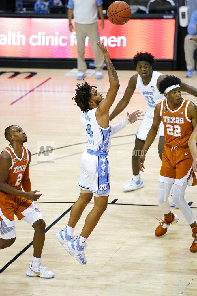 Kathy Kmonicek North Carolina guard R.J. Davis (4) shoots as Texas guard Matt Coleman III (2) and forward Kai Jones (22) watch during the second half of an NCAA college basketball game for the championship of the Maui Invitational, Wednesday, Dec. 2, 2020, in Asheville, N.C. (AP Photo/Kathy Kmonicek)