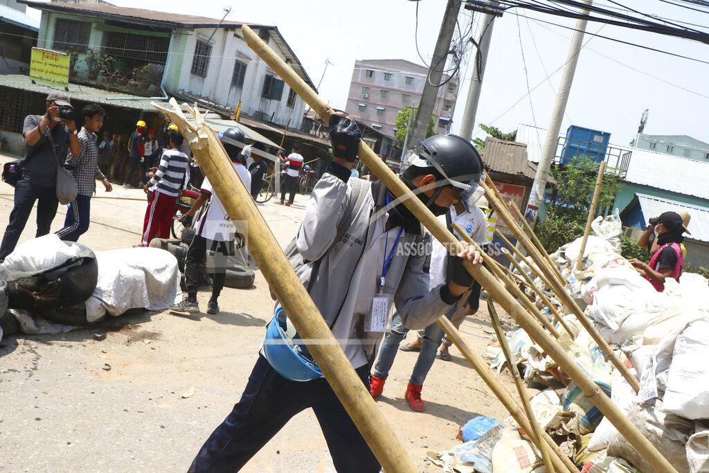 Uncredited Protesters prepare to defend themselves as they gather in Tarkata township, Yangon, Myanmar Saturday, March 20, 20201. Protests against last month's military takeover continued Saturday in cities and town across Myanmar despite a crackdown by security forces that has taken more than 200 lives. (AP Photo)