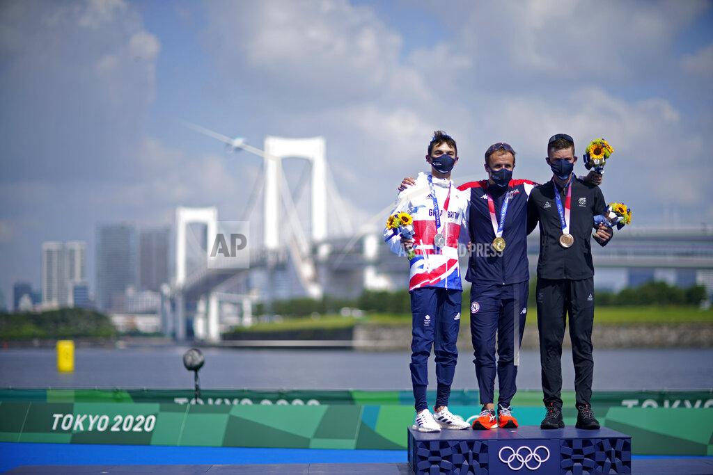 Gold medal winner Kristian Blummenfelt of Norway, center, poses with silver medalist Alex Yee of Great Britain, left, and bronze medalist Hayden Wilde of New Zealand during a medal ceremony for the men's individual triathlon at the 2020 Summer Olympics, Monday, July 26, 2021, in Tokyo, Japan. (AP Photo/David Goldman)