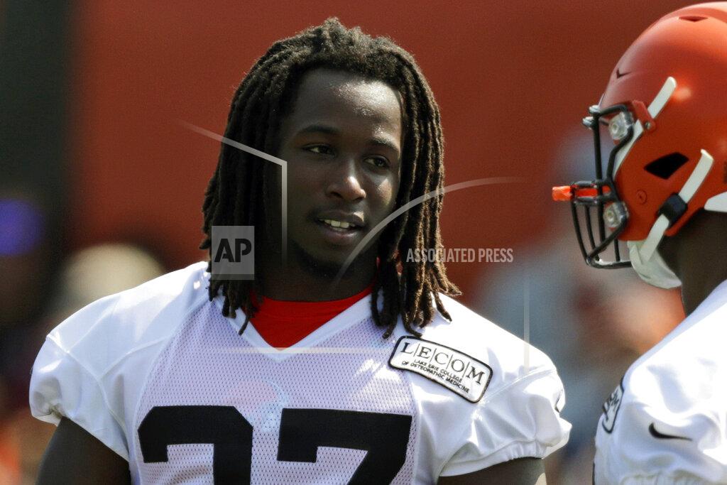 FILE - In this July 25, 2019, file photo, Cleveland Browns running back Kareem Hunt, left, talks with running back Nick Chubb during practice at the NFL football team's training camp facility, in Berea, Ohio. Suspended Browns running back Hunt is practicing while serving the final two games of his NFL ban for two violent alterations. Hunt was on the field with teammates Monday, Oct. 21 for the first time since the end of training camp. (AP Photo/Tony Dejak, File)