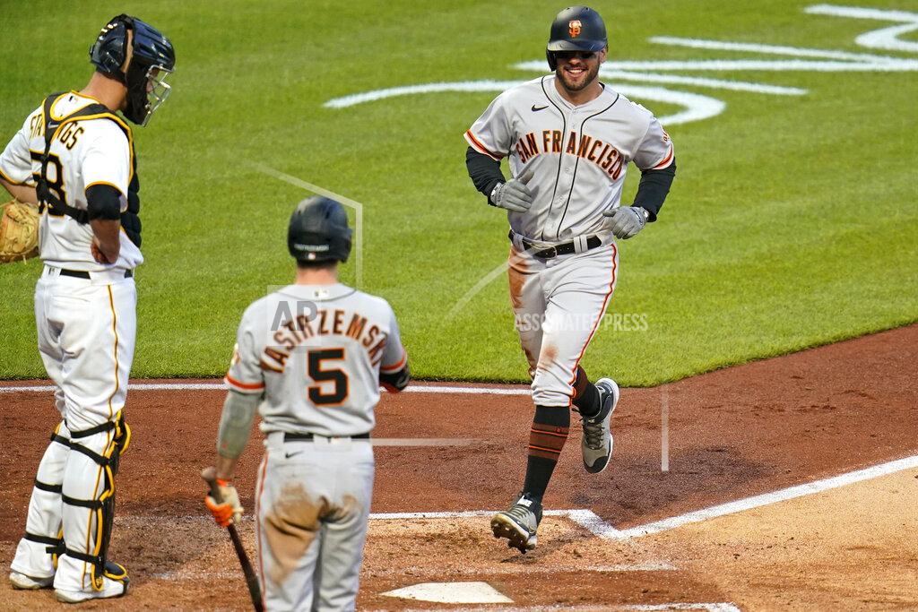 Gene J. Puskar San Francisco Giants' Mike Tauchman, right, scores on an errant pickoff throw to third base by Pittsburgh Pirates catcher Jacob Stallings, left, during the fifth inning of a baseball game in Pittsburgh, Thursday, May 13, 2021.(AP Photo/Gene J. Puskar)