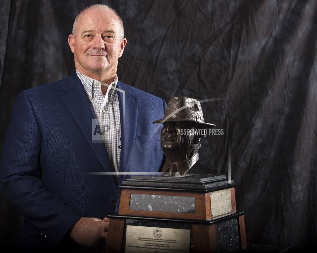 Yi-Chin Lee Fresno State coach Jeff Tedford poses for a photograph with the Paul "Bear" Bryant Coach of the Year Award, before the ceremony Wednesday, Jan. 9, 2019, in Houston. (Yi-Chin Lee/Houston Chronicle via AP)