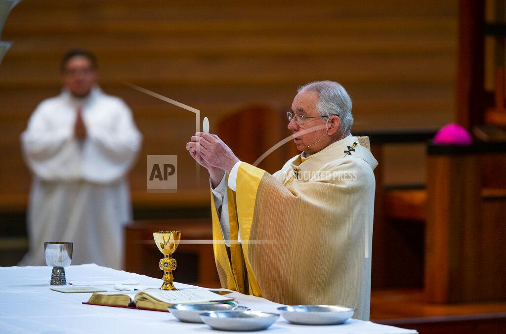 Damian Dovarganes Archbishop Jose H. Gomez celebrates the the Solemnity of the Most Holy Trinity, a Mass with churchgoers present at the Cathedral of Our Lady of the Angels in downtown Los Angeles on Sunday, June 7, 2020. It was his first Mass since public Masses throughout the Archdiocese of Los Angeles were suspended nearly three months ago on March 16 amid the COVID-19 pandemic. Attendance at the Mass is limited to 100 people only, on a first come, first served basis, following the social guidelines and regulations set by the LA County Health Department and the Archdiocese. (AP Photo/Damian Dovarganes)