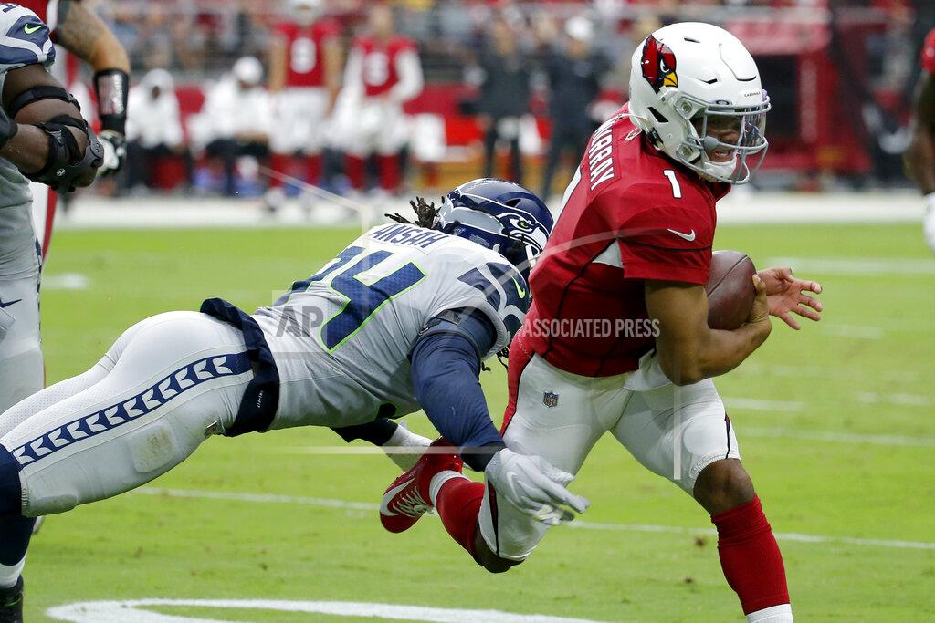 Rick Scuteri Arizona Cardinals quarterback Kyler Murray (1) eludes the reach of Seattle Seahawks defensive end Ezekiel Ansah (94) during the first half of an NFL football game, Sunday, Sept. 29, 2019, in Glendale, Ariz. (AP Photo/Rick Scuteri)