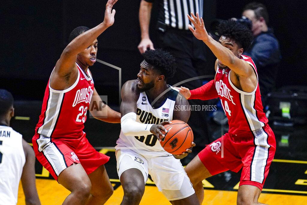 Michael Conroy Ohio State center Zed Key (23) and forward Justice Sueing (14) defend Purdue forward Trevion Williams (50) during the first half of an NCAA college basketball game in West Lafayette, Ind., Wednesday, Dec. 16, 2020. (AP Photo/Michael Conroy)