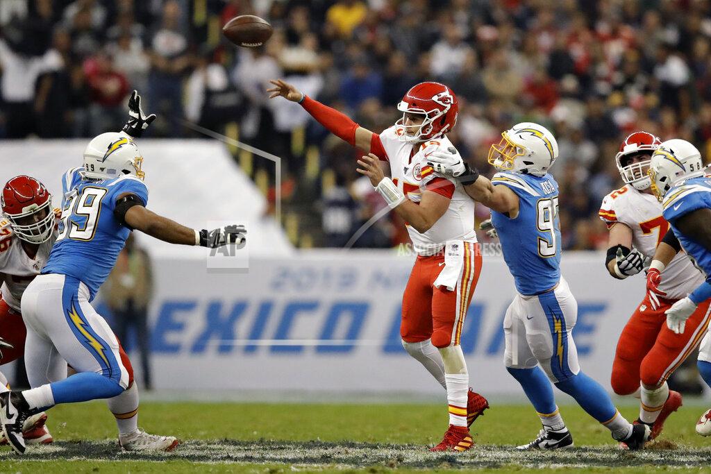 Marcio Jose Sanchez Kansas City Chiefs quarterback Patrick Mahomes throws a pass under pressure from Los Angeles Chargers defensive end Joey Bosa during the second half of an NFL football game Monday, Nov. 18, 2019, in Mexico City. (AP Photo/Marcio Jose Sanchez)