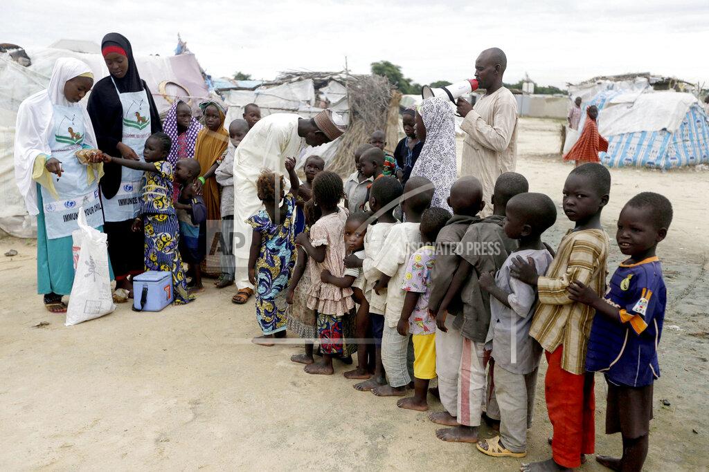 Sunday Alamba FILE - In this Sunday, Aug. 28, 2016 file photo, health officials administer polio vaccine to children at a camp for people displaced by Islamist extremists in Maiduguri, Nigeria. Health authorities on Tuesday, Aug. 25, 2020 are expected to declare the African continent free of the wild poliovirus after decades of effort, though cases of vaccine-derived polio are still sparking outbreaks of the paralyzing disease in more than a dozen countries. (AP Photo/Sunday Alamba, File)
