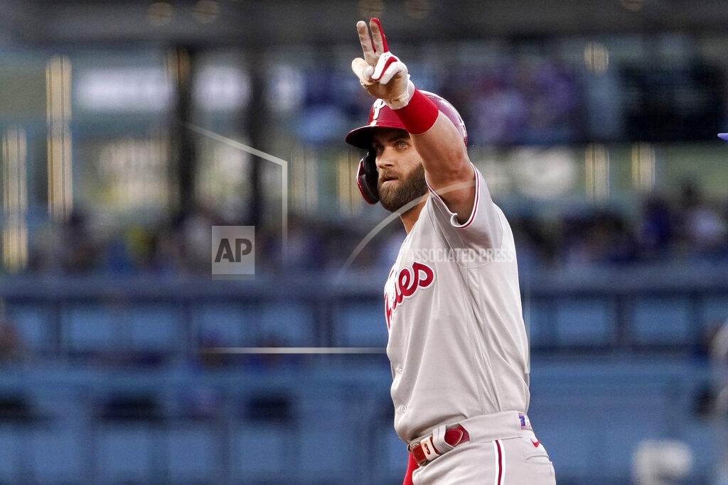 Mark J. Terrill Philadelphia Phillies' Bryce Harper gestures toward his dugout after hitting a double during the first inning of a baseball game against the Los Angeles Dodgers Saturday, May 14, 2022, in Los Angeles. (AP Photo/Mark J. Terrill)