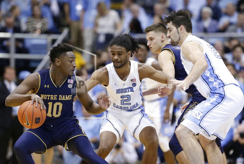 Gerry Broome Notre Dame's TJ Gibbs (10) dribbles the ball while North Carolina's Coby White (2) and Luke Maye, right, defend during the first half of an NCAA college basketball game in Chapel Hill, N.C., Tuesday, Jan. 15, 2019. (AP Photo/Gerry Broome)