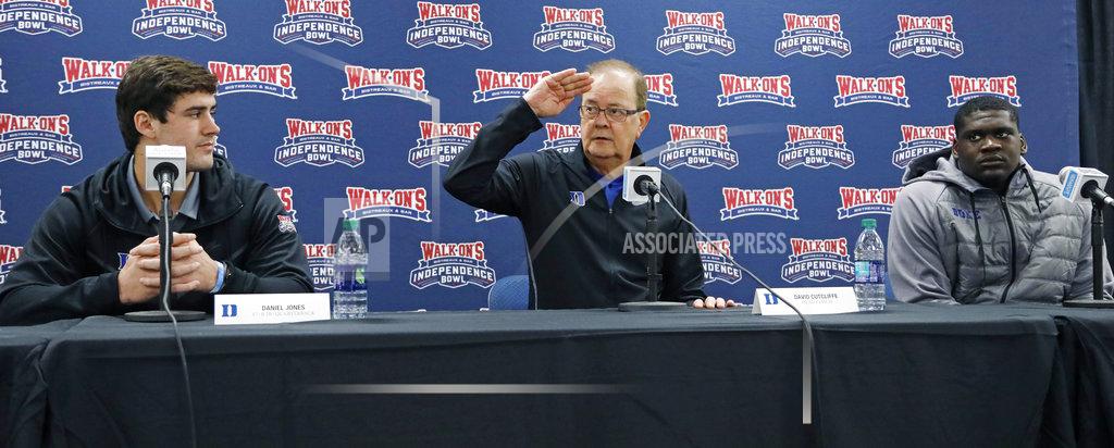Rogelio V. Solis Duke football coach David Cutcliffe, center, salutes the staff of the Independence Bowl for their years' of service to the postseason football game, while quarterback Daniel Jones, left, and defensive tackle Derrick Tangelo, right, listen, at the 2018 Independence Bowl news conference in Shreveport, La., Wednesday, Dec. 26, 2018. Duke faces Temple in the NCAA college football game Thursday. (Rogelio V. Solis/AP)