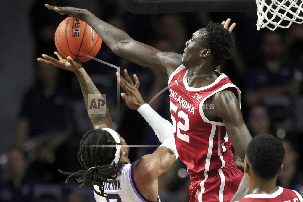 Orlin Wagner Oklahoma forward Kur Kuath (52) blocks a shot by Kansas State guard Cartier Diarra (2) during the first half of an NCAA college basketball game in Manhattan, Kan., Wednesday, Jan. 29, 2020. (AP Photo/Orlin Wagner)