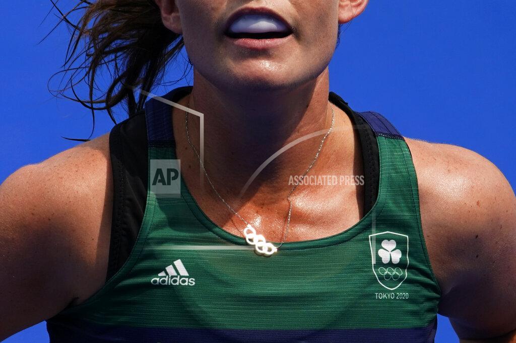 John Locher Ireland midfield Lizzy Holden (14) wears a necklace with the Olympic rings during a women's field hockey match against India at the 2020 Summer Olympics, Friday, July 30, 2021, in Tokyo, Japan. (AP Photo/John Locher)