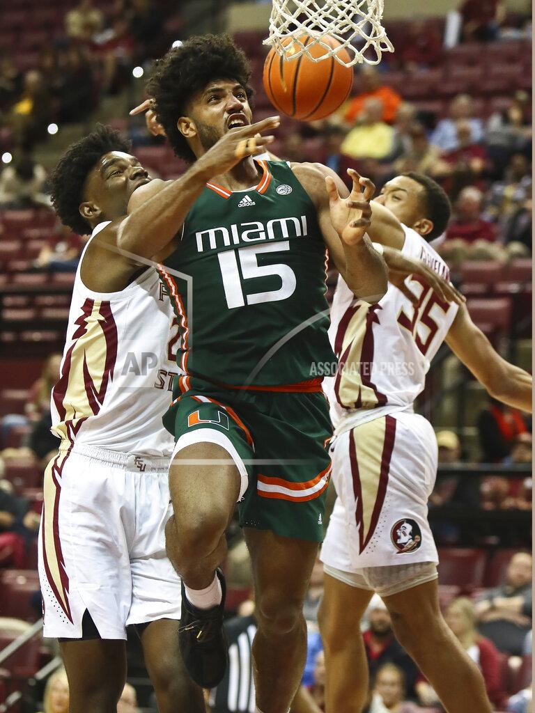 Phil Sears Miami forward Norchad Omier (15) is tied up on a layup attempt by Florida State center Naheem McLeod, left, and Florida State guard Matthew Cleveland (35) in the second half of an NCAA college basketball game in Tallahassee, Fla., Tuesday, Jan. 24, 2023. (AP Photo/Phil Sears)