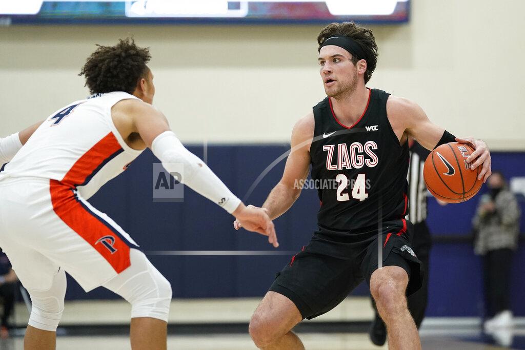 Ashley Landis Pepperdine guard Colbey Ross (4) defends against Gonzaga forward Corey Kispert (24) during the second half of an NCAA college basketball game Saturday, Jan. 30, 2021, in Malibu, Calif. (AP Photo/Ashley Landis)