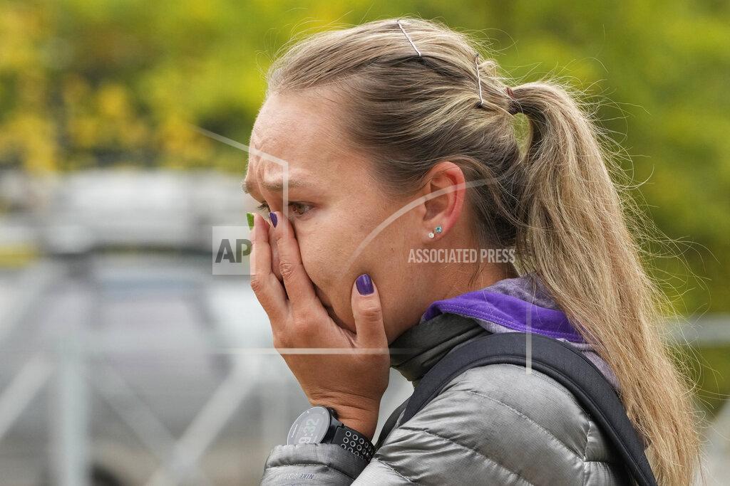 Dmitri Lovetsky A woman reacts as she lays flowers outside the Perm State University following a campus shooting in Perm, about 1,100 kilometers (700 miles) east of Moscow, Russia, Tuesday, Sept. 21, 2021. A student opened fire at the university, leaving a number of people dead and injured, before being shot in a crossfire with police and detained. Beyond saying that he was a student, authorities offered no further information on his identity or a possible motive. (AP Photo/Dmitri Lovetsky)
