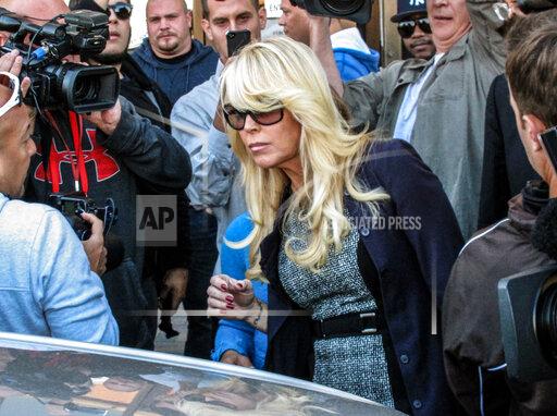 FILE - In this Sept. 24, 2013 file photo, Dina Lohan leaves court in Hempstead, N.Y., after pleading not guilty to drunken driving charges. Lohan pleaded guilty to drunken driving on Tuesday, Sept. 28, 2021, and is expected to be sentenced to 18 days in jail and five years’ probation for rear-ending another car on Long Island and leaving the scene. (AP Photo/Frank Eltman, File)
