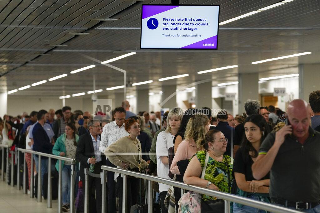 Peter Dejong FILE - Travelers wait in long lines to check in and board flights at Amsterdam's Schiphol Airport, Netherlands, Tuesday, June 21, 2022. (AP Photo/Peter Dejong, File)