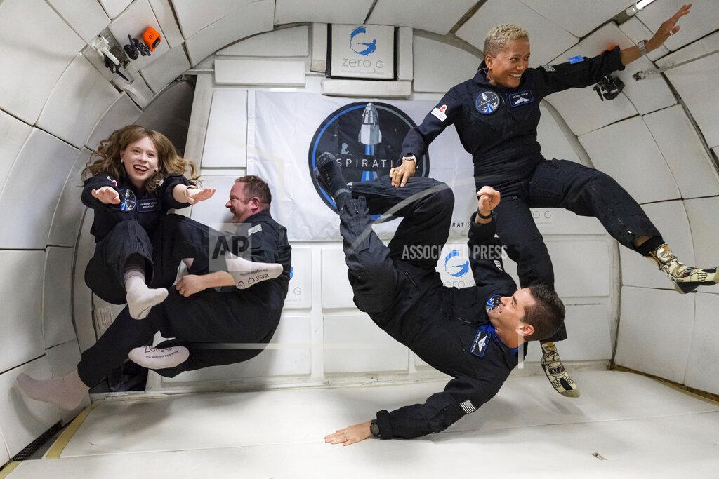 John Kraus In this July 11, 2021 photo provided by John Kraus, from left, Hayley Arceneaux, Chris Sembroski, Jared Isaacman and Sian Proctor float during a zero gravity flight out of Las Vegas. The plane, a modified Boeing 727, flies multiple parabolic arcs to provide 20-30 seconds of weightlessness. (John Kraus/Inspiration4 via AP)