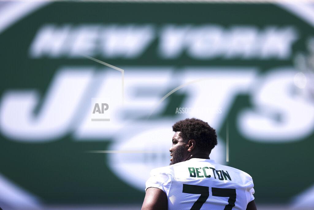 Rich Schultz New York Jets offensive tackle Mekhi Becton (77) looks on during practice at the team's NFL football training facility, Saturday, July. 31, 2021, in Florham Park, N.J. (AP Photo/Rich Schultz)