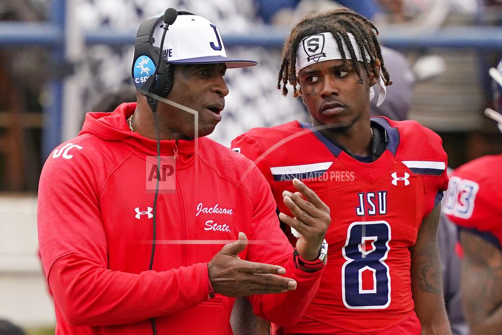 Rogelio V. Solis Jackson State football coach Deion Sanders, left, confers with quarterback Quincy Casey (8) during the second half of an NCAA college football game against Edward Waters in Jackson, Miss., Sunday, Feb. 21, 2021. (AP Photo/Rogelio V. Solis)