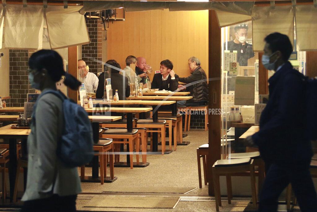 Koji Sasahara People dine at a restaurant in Tokyo, Monday, Oct. 25, 2021. People in Tokyo can eat and drink in bars and restaurants later in the evening starting Monday as officials ease social distancing rules with the country’s daily coronavirus cases reaching their lowest levels in more than a year. (AP Photo/Koji Sasahara)