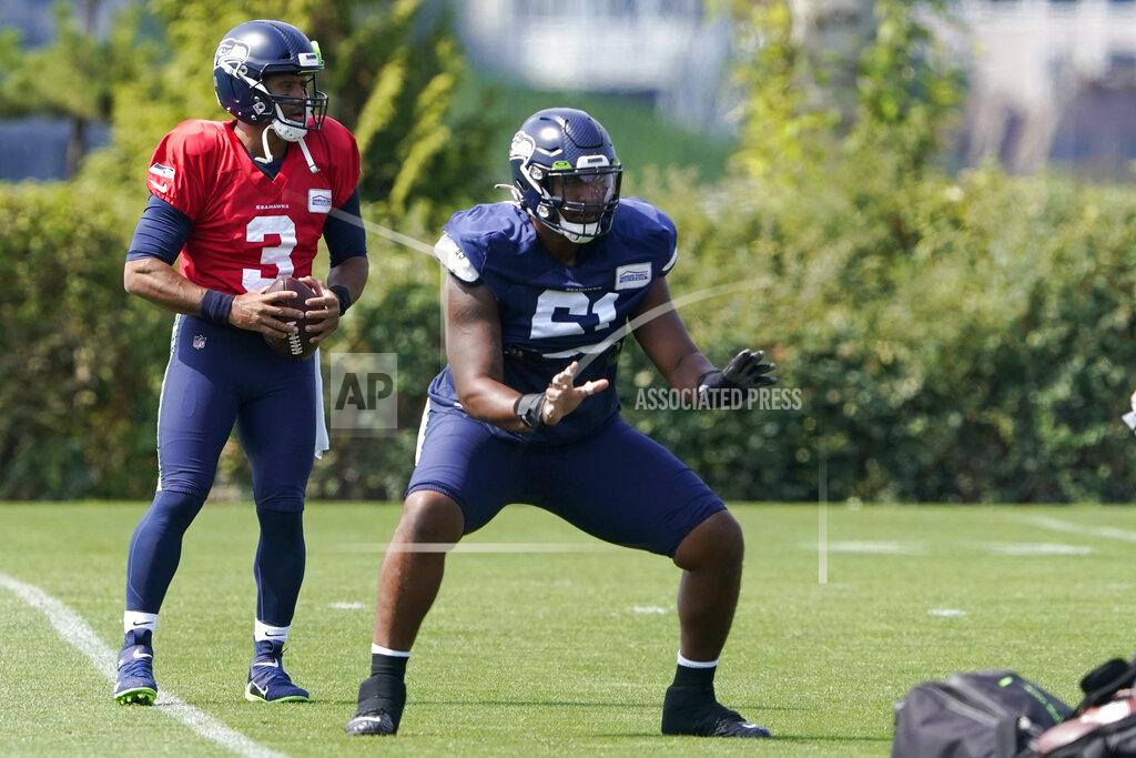 Ted S. Warren Seattle Seahawks quarterback Russell Wilson (3) takes a snap from center Kyle Fuller during NFL football practice Wednesday, Aug. 25, 2021, in Renton, Wash. (AP Photo/Ted S. Warren)