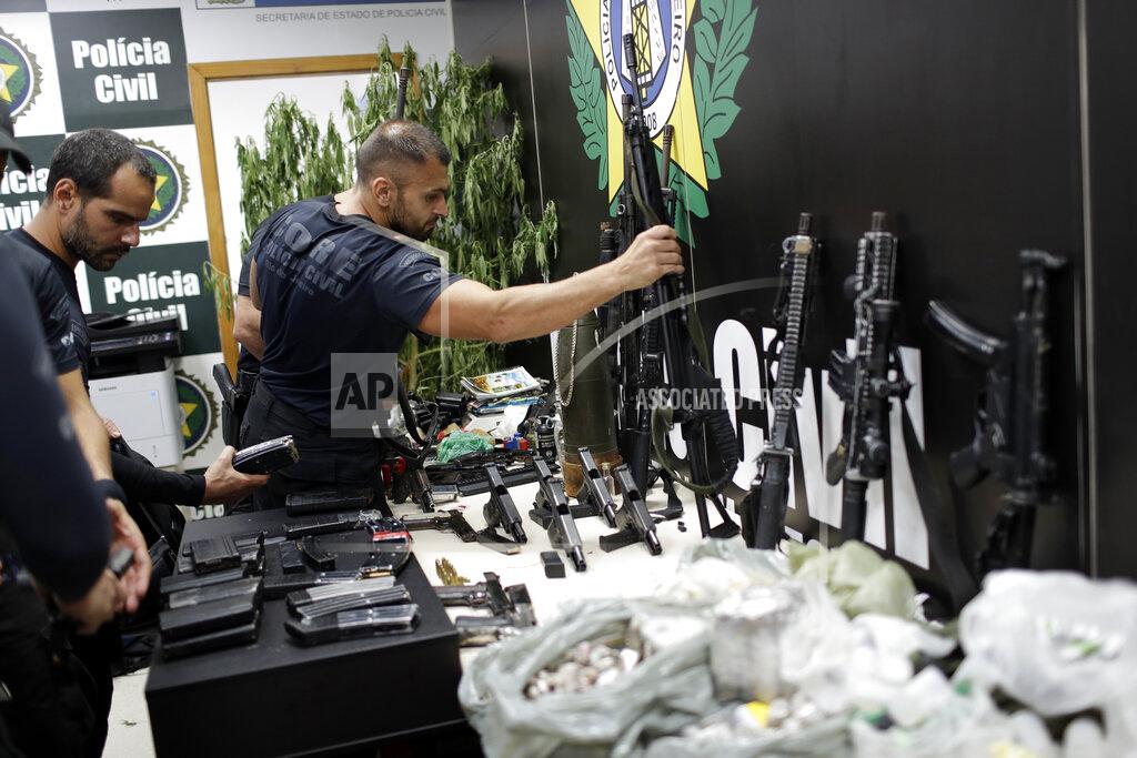 Silvia Izquierdo Weapons and drugs seized during a police raid are displayed for the press at city police headquarters in Rio de Janeiro, Brazil, Thursday, May 6, 2021. According to the press office of Rio's civil police, at least 25 people died during the raid, including one police officer and 24 suspects. (AP Photo/Silvia Izquierdo)