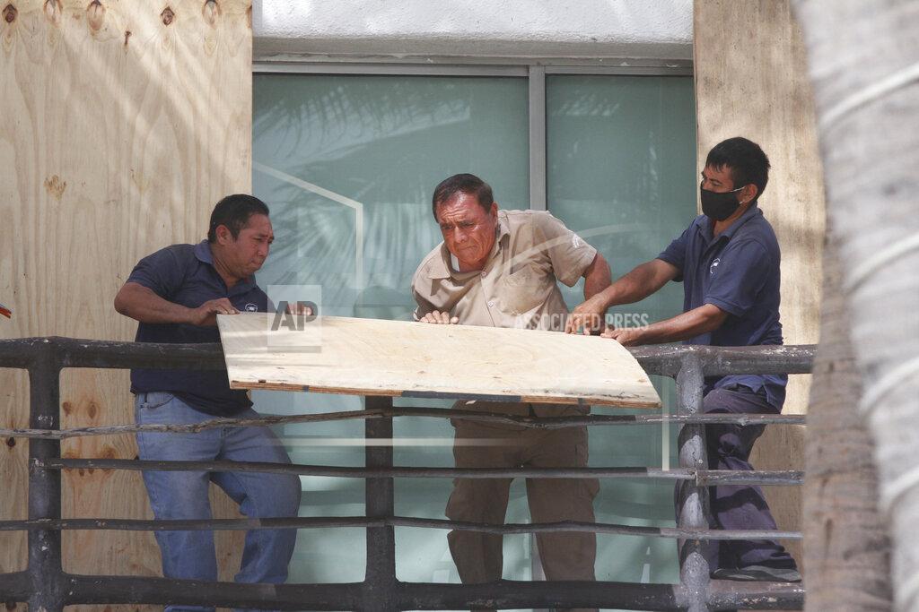 Tomas Stargardter Beach hotel workers cover doors and windows with plywood as they prepare for the arrival of Tropical Storm Zeta in Playa del Carmen, Mexico, Monday, Oct. 26, 2020. A strengthening Tropical Storm Zeta is expected to become a hurricane Monday as it heads toward the eastern end of Mexico's resort-dotted Yucatan Peninsula and then likely move on for a possible landfall on the central U.S. Gulf Coast at midweek. (AP Photo/Tomas Stargardter)