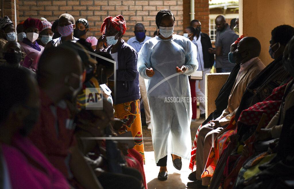 Thoko Chikondi Numbers are handed out to people who wait to receive the AstraZeneca COVID-19 vaccine at Ndirande Health Centre in Blantyre Malawi, Monday, March 29, 2021. Malawi is vaccinating health care workers, elderly and those with health conditions that put them at higher risk of severe COVID-19, using the AstraZeneca doses that arrived early in March. (AP Photo/Thoko Chikondi)
