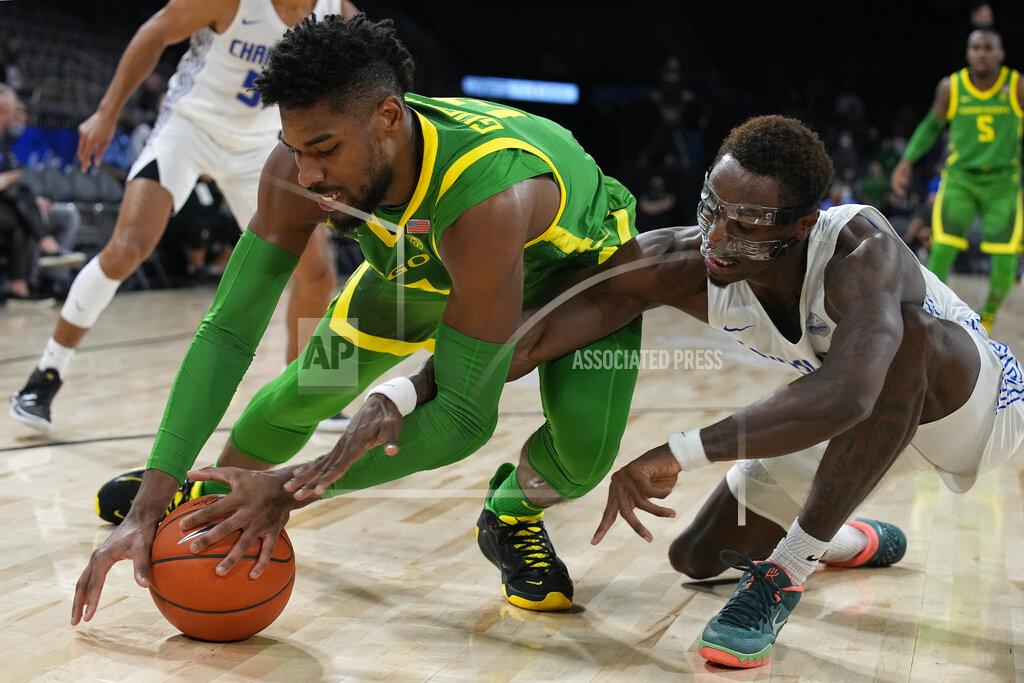 Rick Scuteri Oregon forward Quincy Guerrier, left, and Chaminade forward Paris Taylor fight for the ball in the first half during an NCAA college basketball game at the Maui Invitational in Las Vegas, Monday, Nov. 22, 2021. (AP Photo/Rick Scuteri)