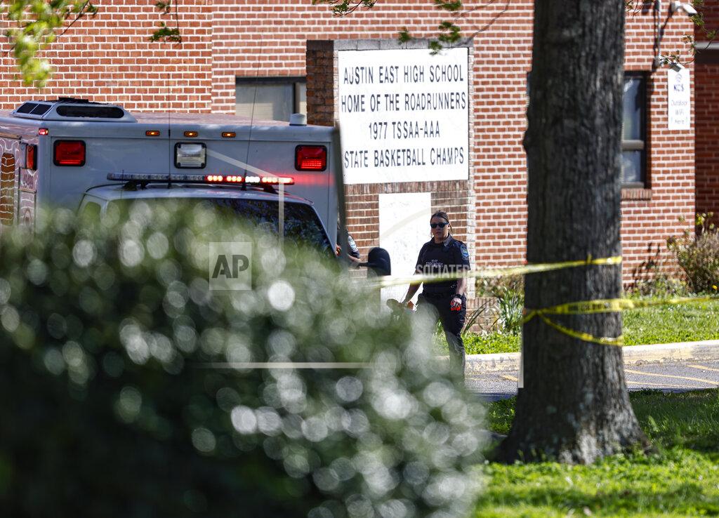Wade Payne A member of the Knoxville police forensics team works the scene of a shooting at Austin-East Magnet High School in Knoxville, Tenn., Monday, April 12, 2021. (AP Photo/Wade Payne)