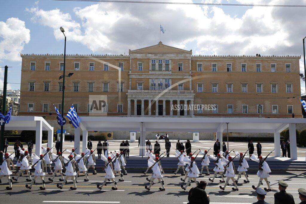 Thanassis Stavrakis Members of the Presidential Guard parade in front of the Greek Parliament in Athens, Thursday, March 25, 2021. Greece's celebrations for the bicentenary of the start of the nation's war of independence are culminating in a military parade and warplane flyby in Athens on Thursday, the country's Independence Day. (AP Photo/Thanassis Stavrakis)