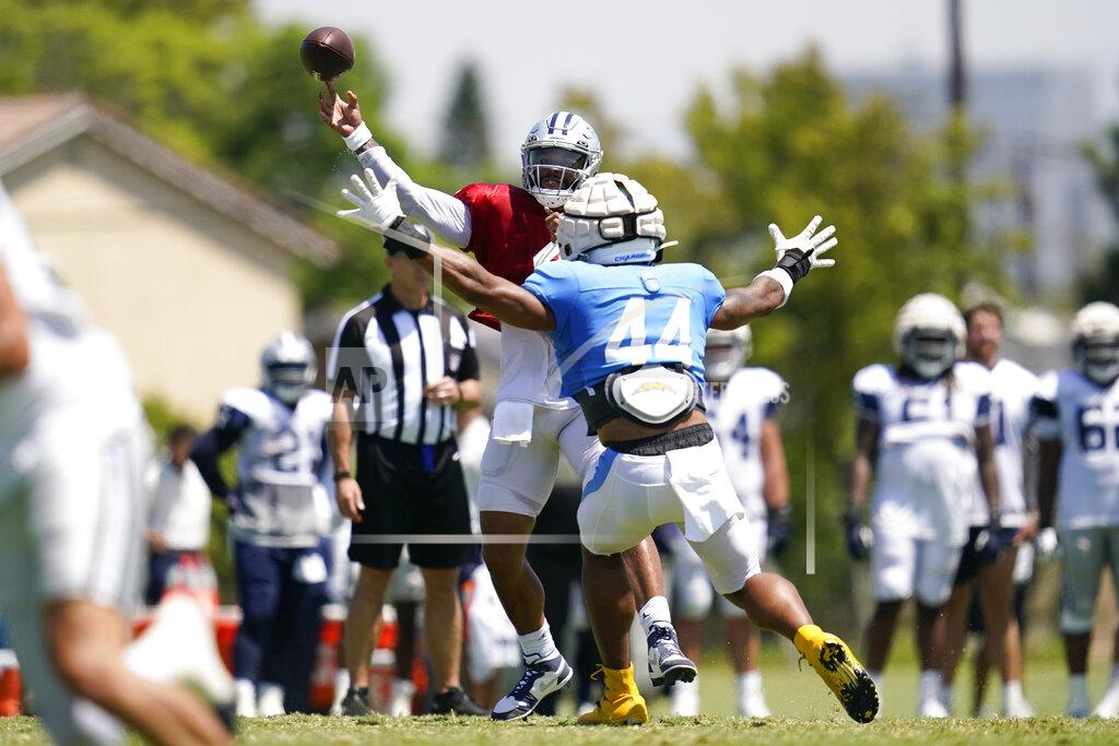 Ashley Landis Dallas Cowboys quarterback Dak Prescott (4) and Los Angeles Chargers offensive linebacker Jamal Davis II (44) participate in drills during a combined NFL practice at the Los Angeles Rams' practice facility in Costa Mesa, Calif. Thursday, Aug. 18, 2022. (AP Photo/Ashley Landis)