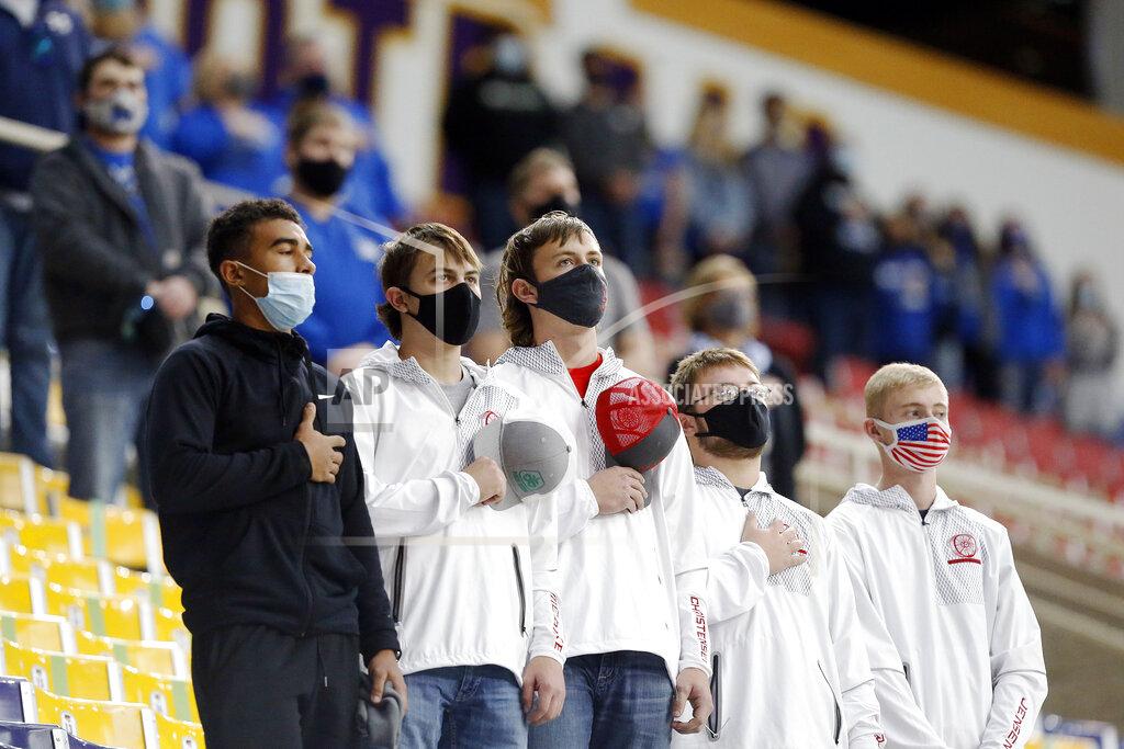 Liz Martin Fans stand for the Star-Spangled Banner before an 8-man high school football semifinal playoff game between Montezuma and Remsen St. Mary's at the UNI-Dome in Cedar Falls, Iowa, Thursday, Nov. 12, 2020. (Liz Martin/The Gazette via AP)