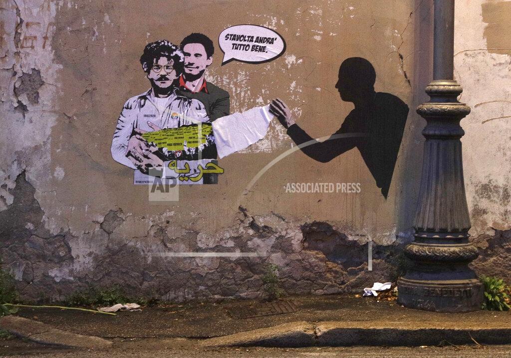 Gregorio Borgia FILE - In this Feb. 19, 2020 file photo, a mural depicting detained Egyptian human rights advocate and student at the University of Bologna in Italy Patrick George Zaki, being hugged from behind by Italian researcher Giulio Regeni, who was murdered in Cairo in 2016, is displayed on a wall in Rome. The trial of Zaki who has been imprisoned for over a year in Egypt began Tuesday, Sept. 14, 2021 amid calls by human rights advocates for his immediate release, his lawyers said. Zaki appeared before a State Security Misdemeanors Court in the Delta town of Mansoura to face charges of spreading false news about Egypt domestically and abroad. Writing in Italian at top reads: "This time it will all go well", and in Arabic at the bottom reads "freedom." (AP Photo/Gregorio Borgia, File)
