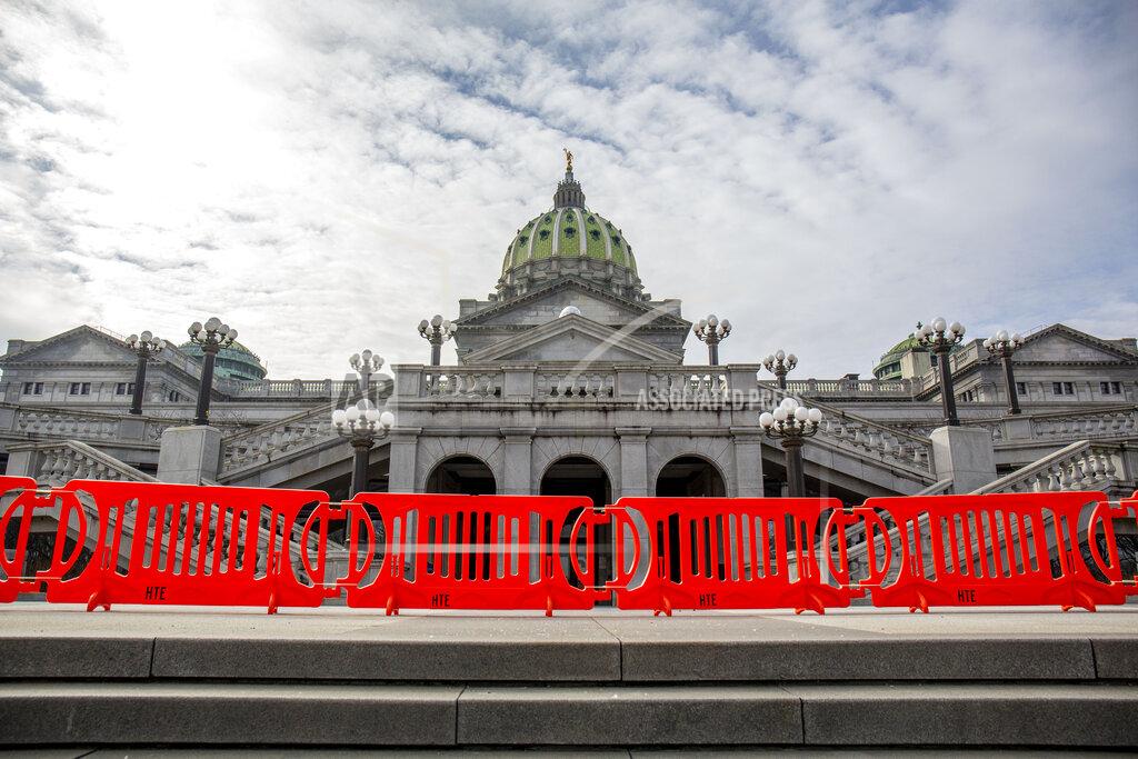 Mark Pynes Orange fencing is set up outside the Pennsylvania State Capitol in Harrisburg, Pa., Thursday, Jan. 14, 2021, in advance of Joe Biden's Presidential Inaugural in Washington D.C. on Jan. 20. (Mark Pynes/The Patriot-News via AP)
