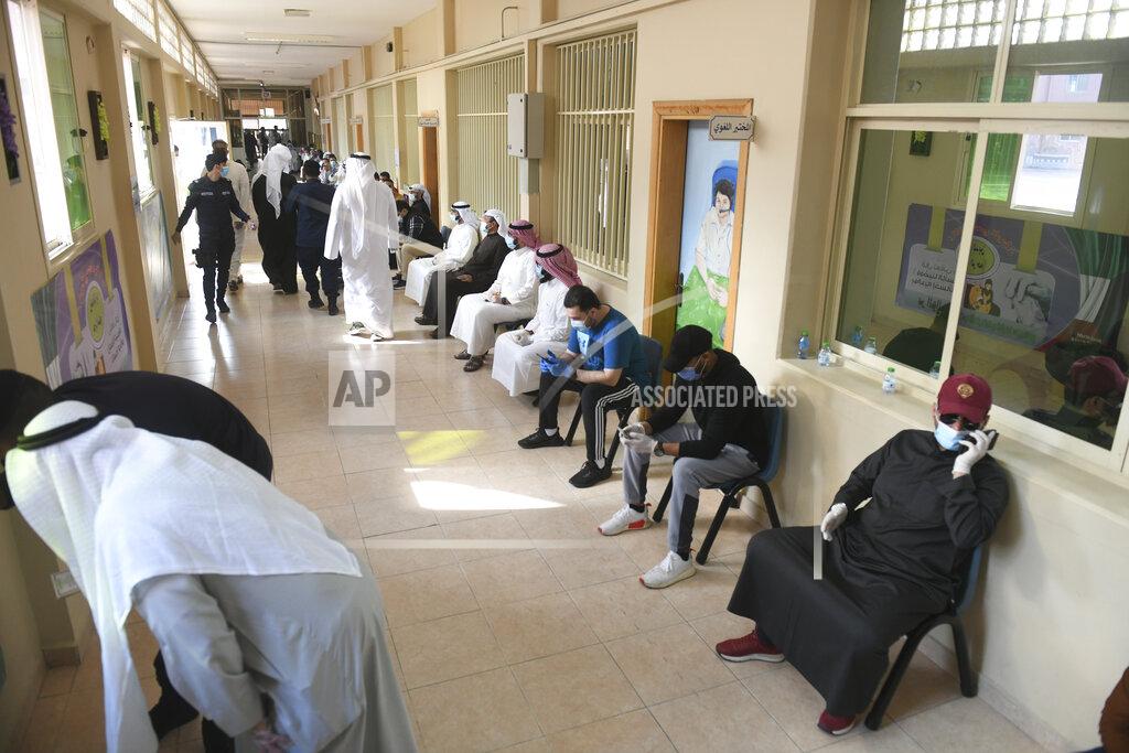Jaber Abdulkhaleg People wait to cast their votes for parliamentary elections in the town of Hawally, Kuwait, Saturday, Dec. 5, 2020. (AP Photo/Jaber Abdulkhaleg)