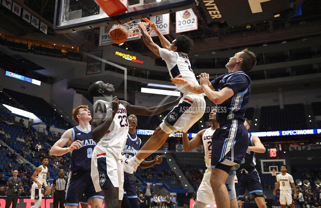 Jessica Hill Connecticut's James Bouknight dunks a rebound from his own shot during the second half of an NCAA college basketball game against Maine, Sunday, Dec. 1, 2019, in Hartford, Conn. (AP Photo/Jessica Hill)