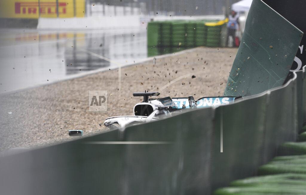 Britain's Lewis Hamilton from team Mercedes-AMG Petronas slips as he leads the track during the German Formula One Grand Prix at the Hockenheimring racetrack in Hockenheim, Germany, Sunday, July 28, 2019. (Sebastian Gollnow/dpa via AP)