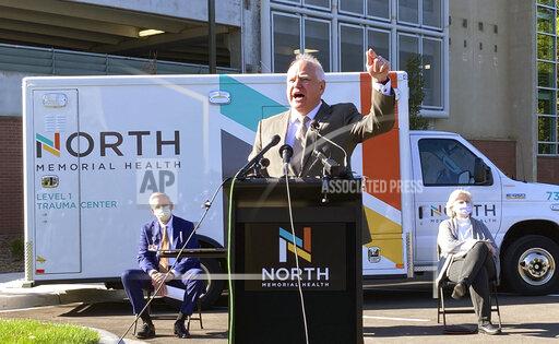 Minnesota Gov. Tim Walz announces measures on Friday, Oct. 15, 2021, to use the Minnesota National Guard to alleviate staffing shortages at health care facilities that have been hit hard by the COVID-19 surge. The governor spoke outside North Memorial Health Hospital in the Minneapolis suburb of Robbinsdale. (AP Photo/Grant Schulte)